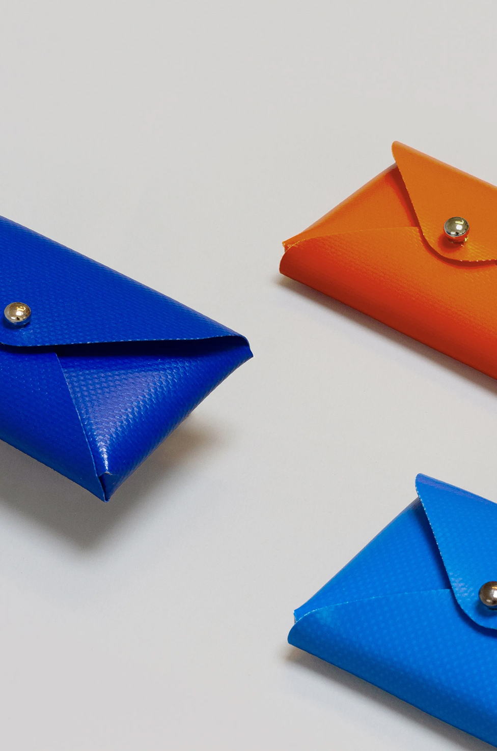 Tasket cardholders in blue, orange, and light blue